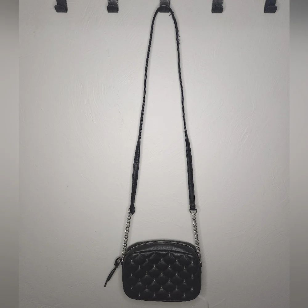 Rebecca Minkoff• Mini quilted studded black crossbody bag. 7.25” x 2.25” x 5.25”